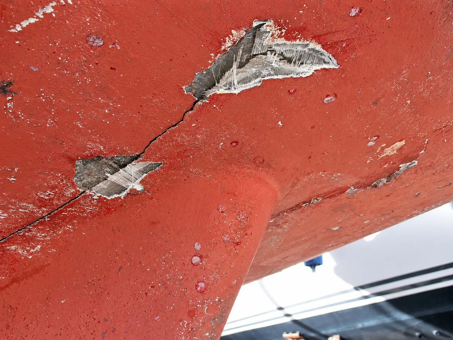 Impact damage and cracking on a hull bottom documented during investigation