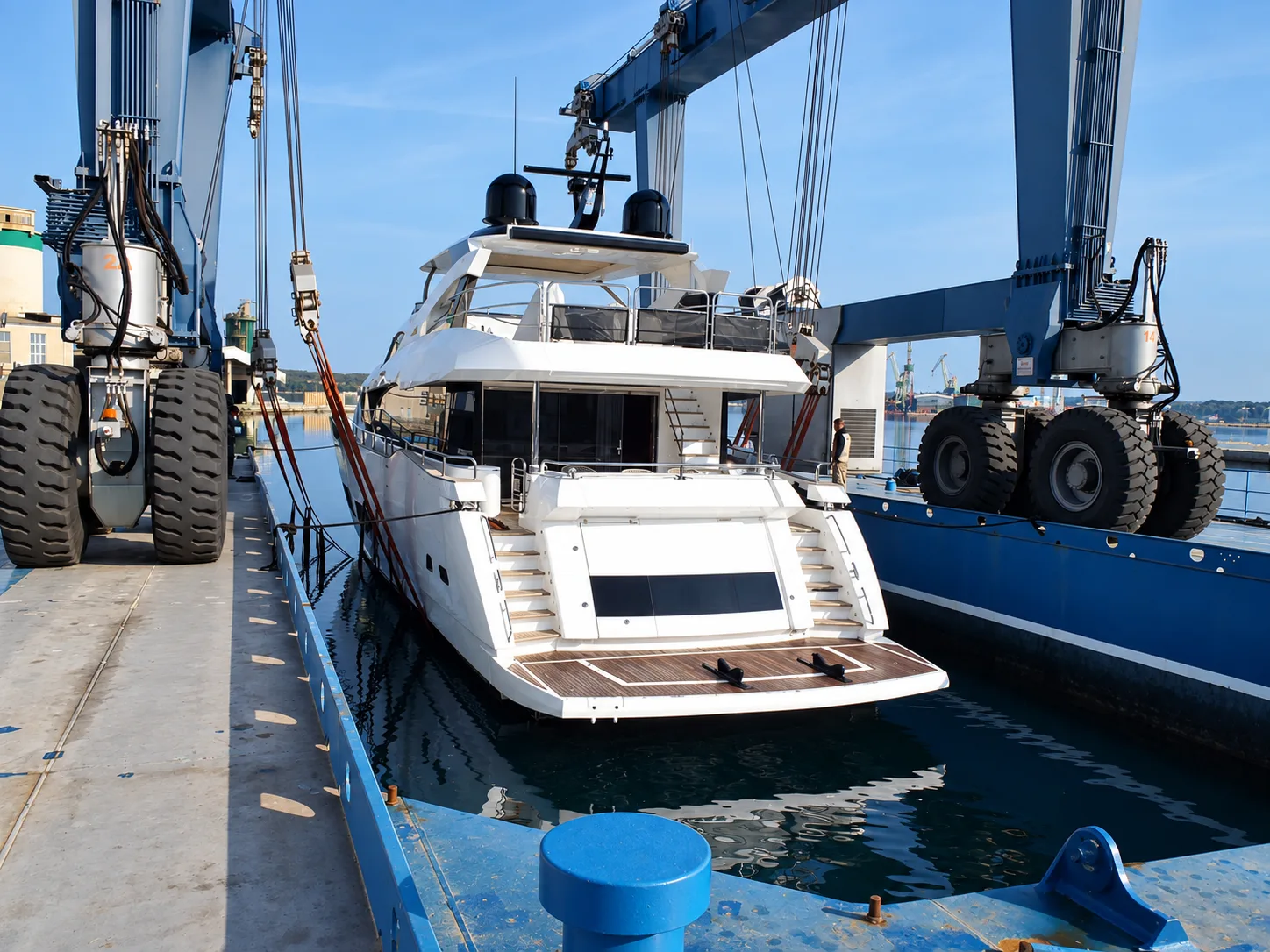 Motor yacht in a travel lift for hull inspection during a pre-purchase survey